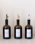 Three amber glass bottles with labels on a white background