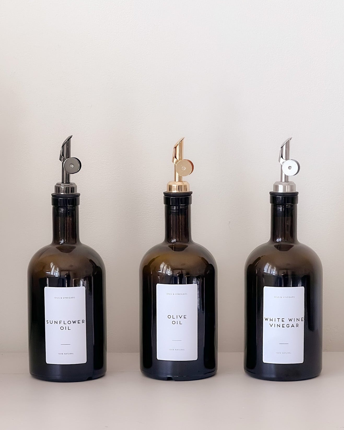 Three amber glass bottles with labels on a white background